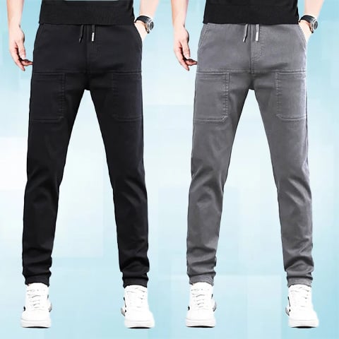 Two men side by side wearing the drawstring trousers, one in black and one in light grey 25