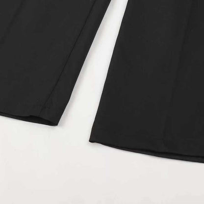 Flat-lay close-up of the black trouser hems laid side by side, showing the clean stitched edges and the front crease. 15