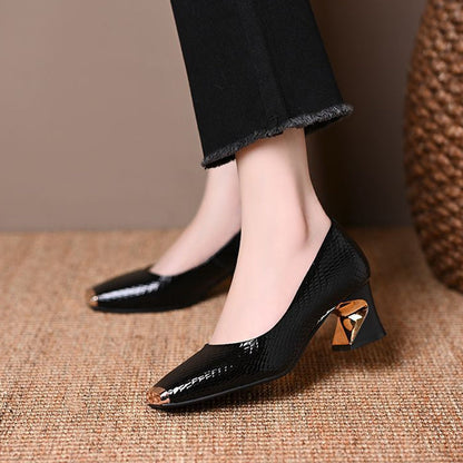 Side view of black patent snake-effect pumps on a model, showing the gold toe caps and sculpted gold-accent heels. 4