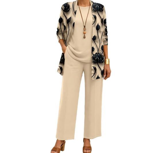Model wearing the beige set: black lotus-print open cardigan over a plain round-neck top and wide-leg trousers, with a long pendant necklace. 1