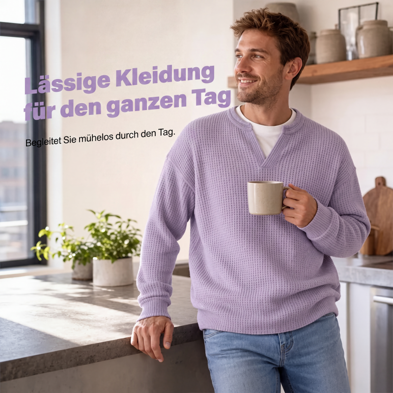 Smiling model leans on a kitchen counter holding a mug, wearing the lilac waffle knit top 5