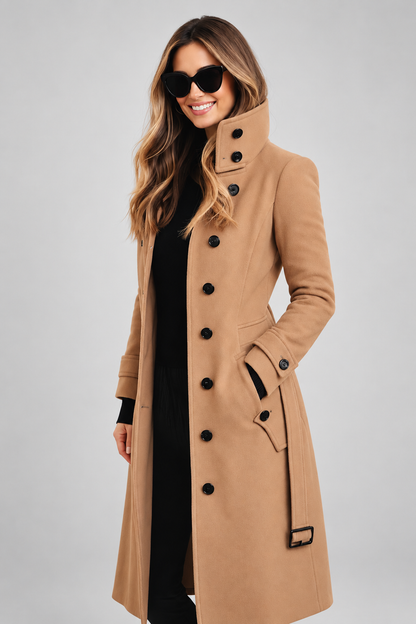 Camel coat worn open over black, with buttoned stand collar and belt, against a plain grey backdrop 4