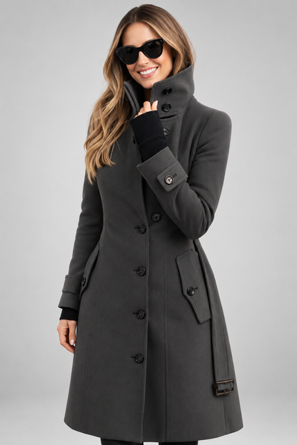 Charcoal grey coat with high buttoned collar, flap pockets and belt, worn by a smiling model 6