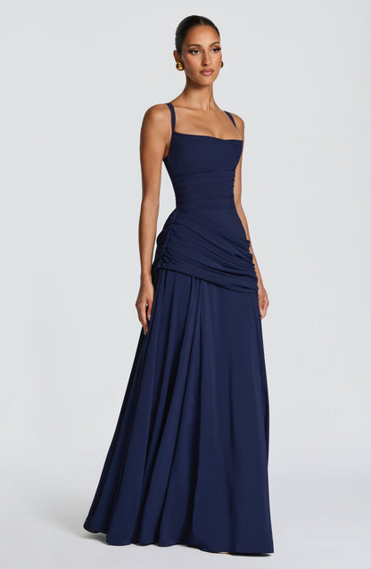 Navy dress seen from the side, showing the gathered hip ruching and flowing chiffon skirt 10