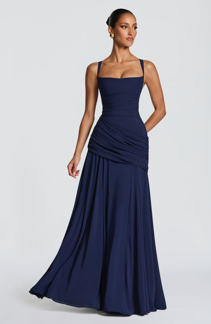 Navy dress worn at an angle with the skirt swishing, showing the draped hip panel 6