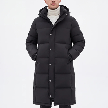 Model in the black hooded coat, zipped and studded closed over a cream roll-neck jumper 7