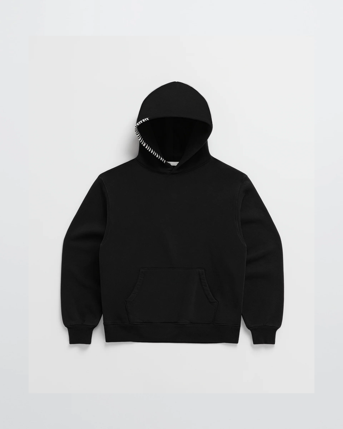Flat lay of the black hoodie with white contrast stitching along the hood edge and a kangaroo pocket 5