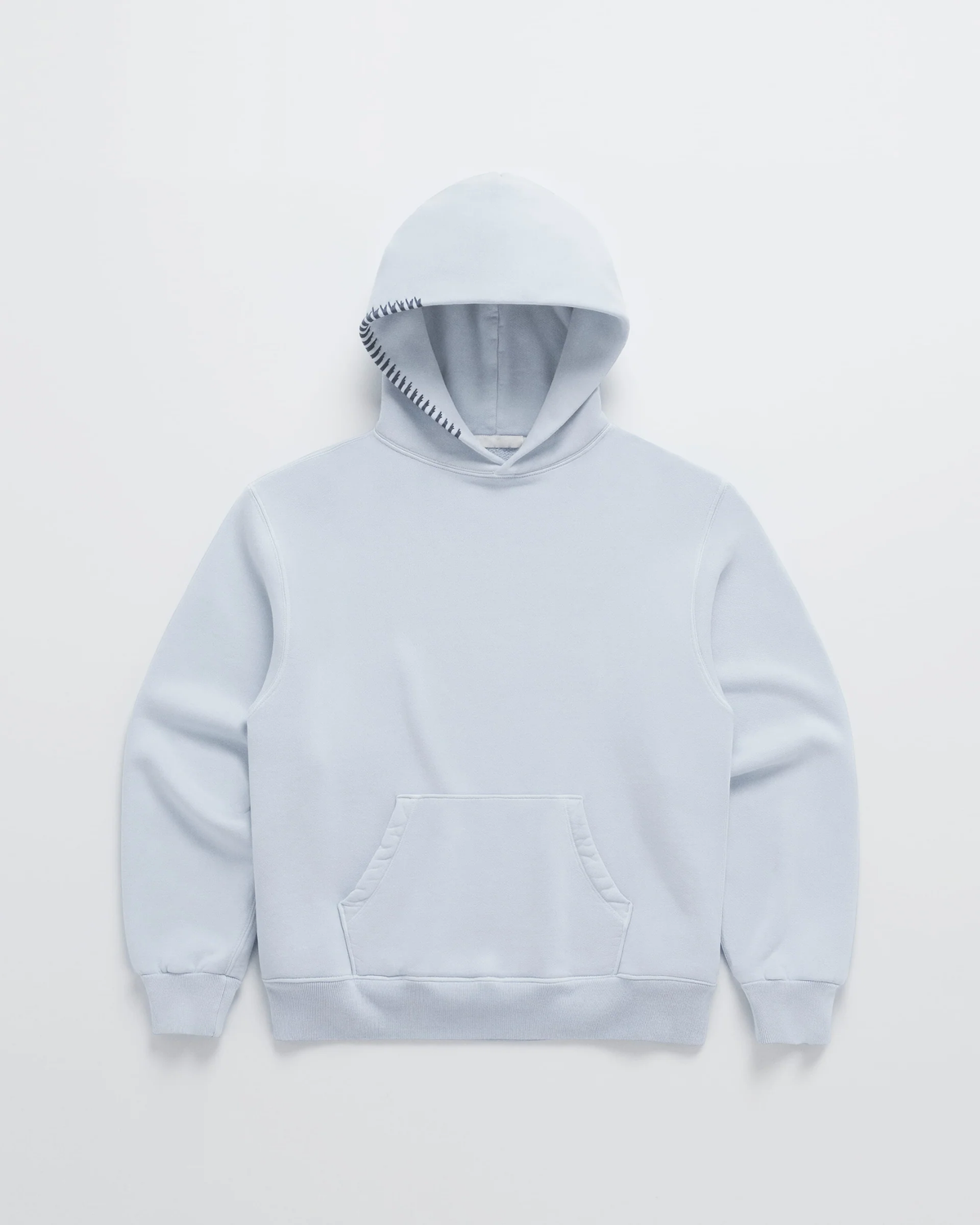 Flat lay of the pale blue hoodie with dark navy stitching along the hood edge and ribbed cuffs 4