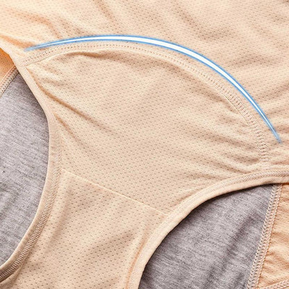 Close-up of the curved gusset on beige mesh briefs, with grey absorbent lining visible at the sides and a blue curved highlight. 11
