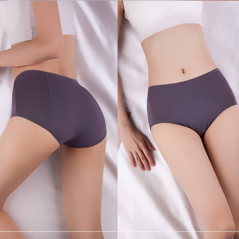 Two views of a model lying on white sheets in dusky purple briefs, the back with mesh side panel and the front. 5