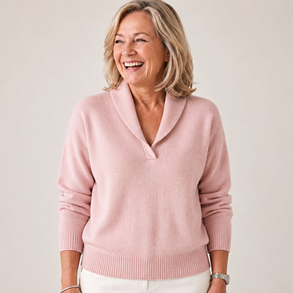 Woman laughing and looking away in the jumper in soft pink, with a ribbed hem and shawl collar. 8