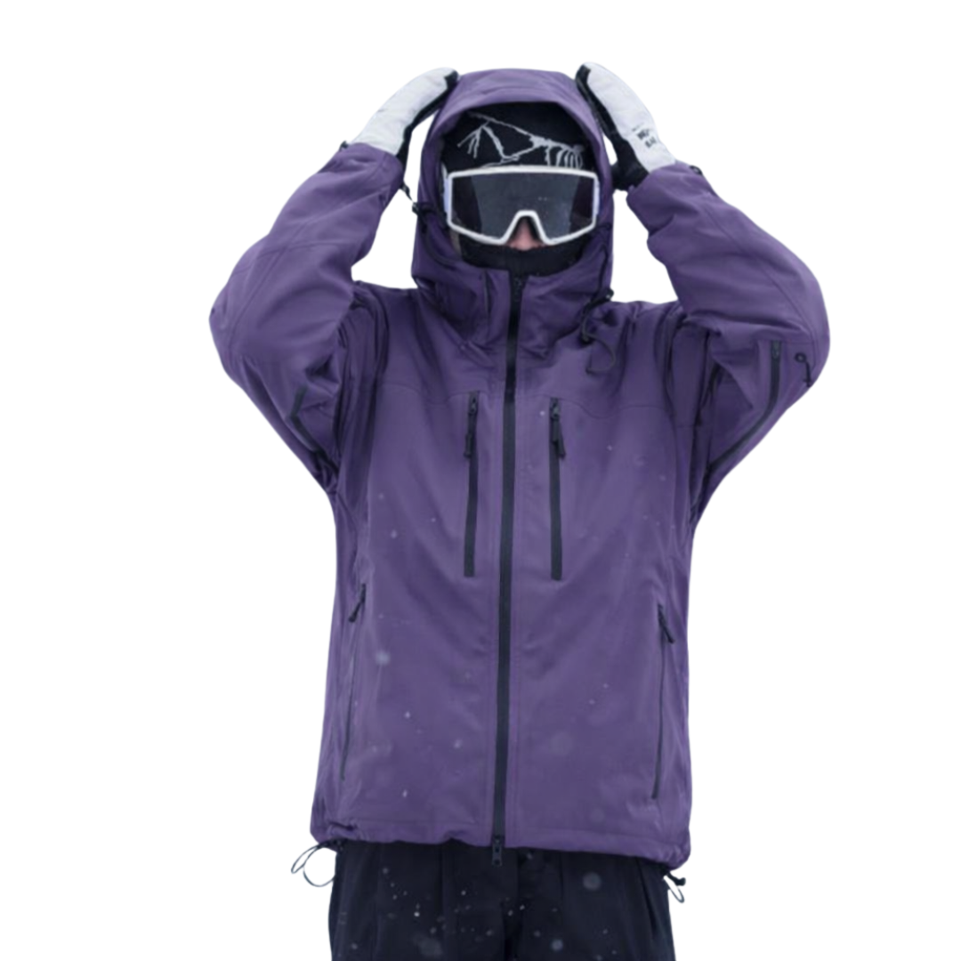 Model in a purple hooded jacket with both hands raised to the hood, wearing goggles 1