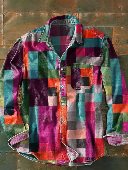 Same patchwork shirt laid flat in a pink, orange, teal and purple colourway, showing collar, chest pocket and buttons. 2