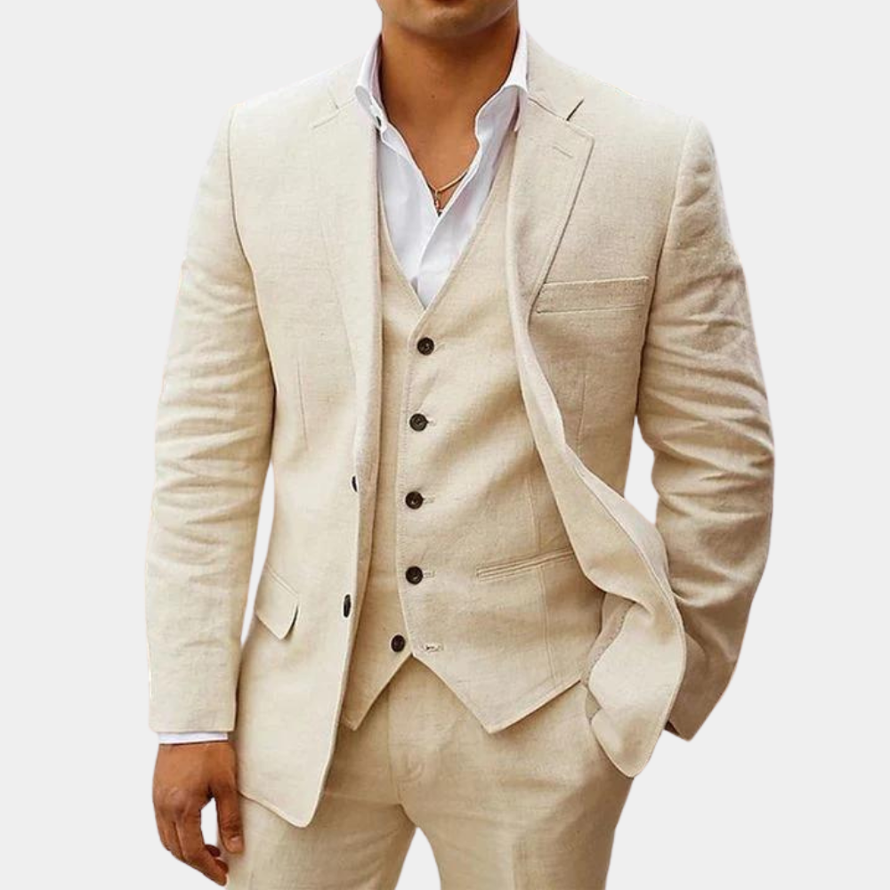 Model in a cream three-piece suit with notch lapel jacket, buttoned vest and trousers, worn over a white open-collar shirt. 1