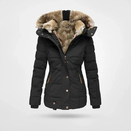 Front view of the quilted hooded jacket in black, with a thick faux-fur lined hood, popper placket and zipped pockets. 1