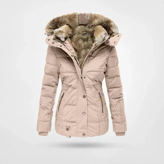 Front view of the quilted hooded jacket in soft beige, with a warm fur-lined hood, press-stud front and zipped pockets. 3