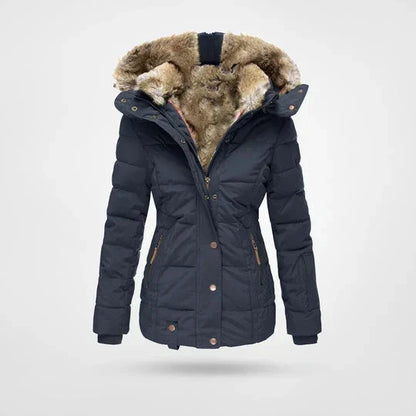Front view of the quilted hooded jacket in navy blue, showing the fur-lined hood, popper fastenings and zipped side pockets. 5