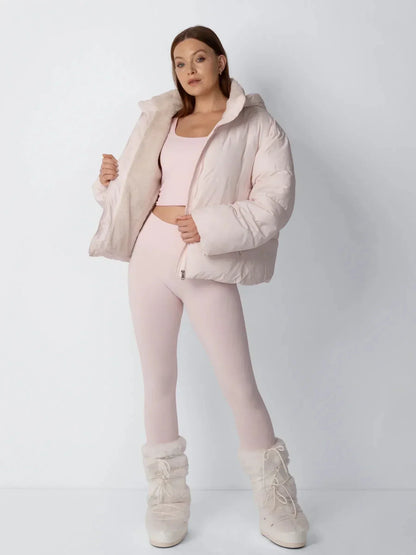 Full-length view of a pale pink puffer jacket held open to reveal the fleece lining, styled with matching leggings 8