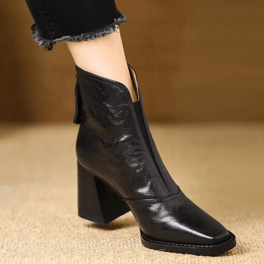 Black glossy leather version of the square-toed block heel ankle boot, worn with frayed black jeans 2