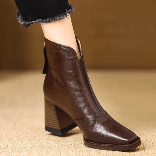 Dark brown leather ankle boot with square toe and stacked block heel, worn with frayed black jeans 1