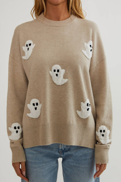 Close front view of the beige knit showing fluffy white ghost appliqués on the body and sleeves 2