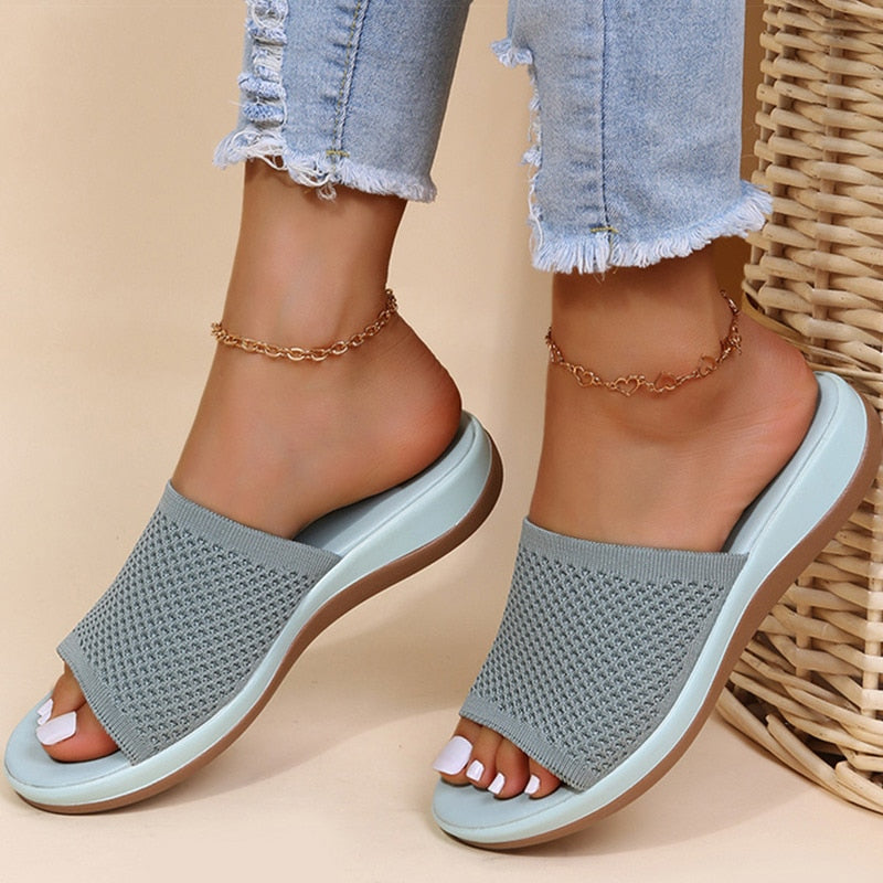 Slides in grey knit with a pale blue sole, worn with frayed jeans and gold anklets 3