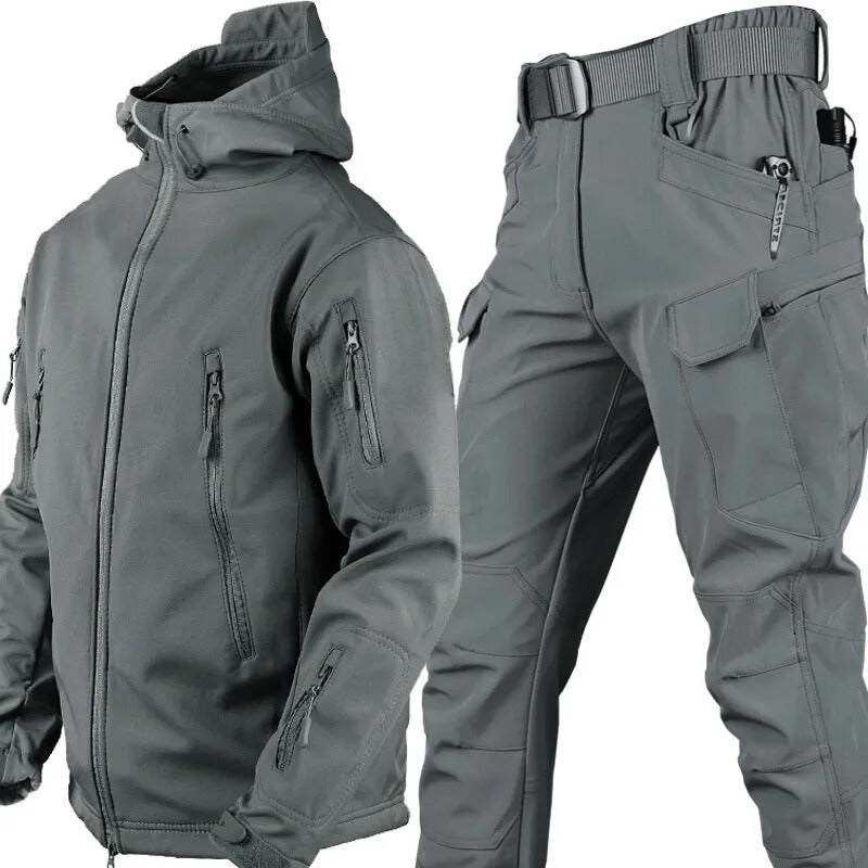 Grey hooded jacket and matching cargo trousers with belt shown together, with zipped pockets on the jacket and large flap pockets on the trousers. 10