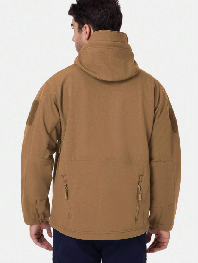 Back view of the tan hooded jacket on a model, showing the high collar, sleeve patches and two zipped lower back pockets. 14