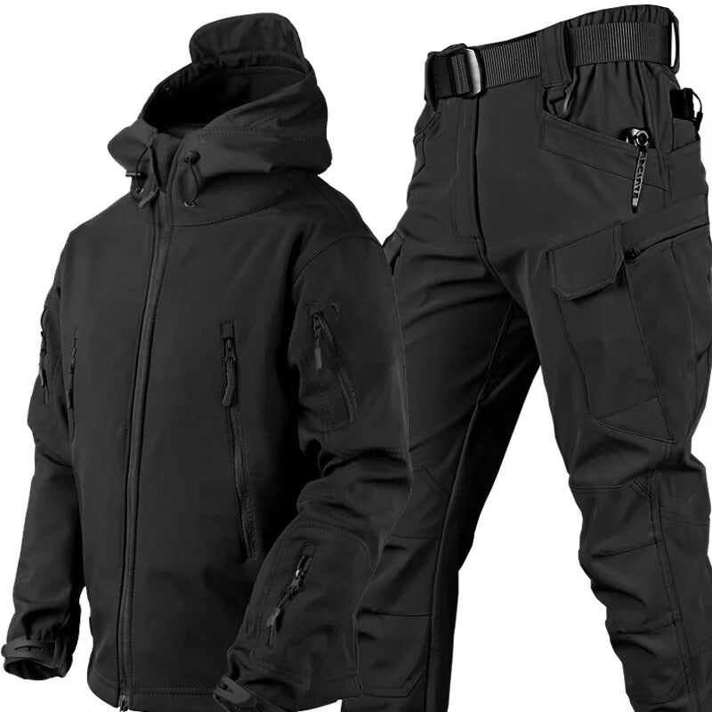 Black hooded zip-up jacket with sleeve and chest pockets beside matching black cargo trousers with belt and flap pocket, shown together as a set. 21