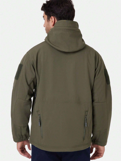Back view of the olive green hooded jacket on a model, showing the raised hood, sleeve patches and two lower zip pockets. 5