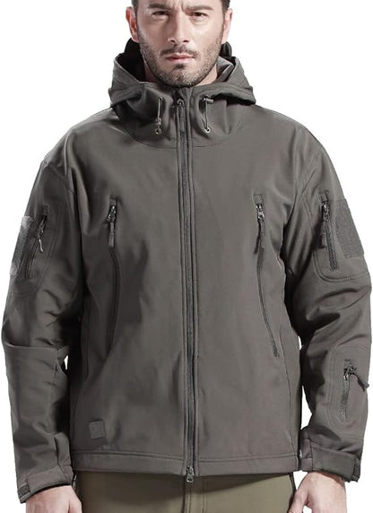 Man wearing the grey hooded jacket zipped up, facing the camera, showing the drawcord hood, chest zip pockets and sleeve patches. 8